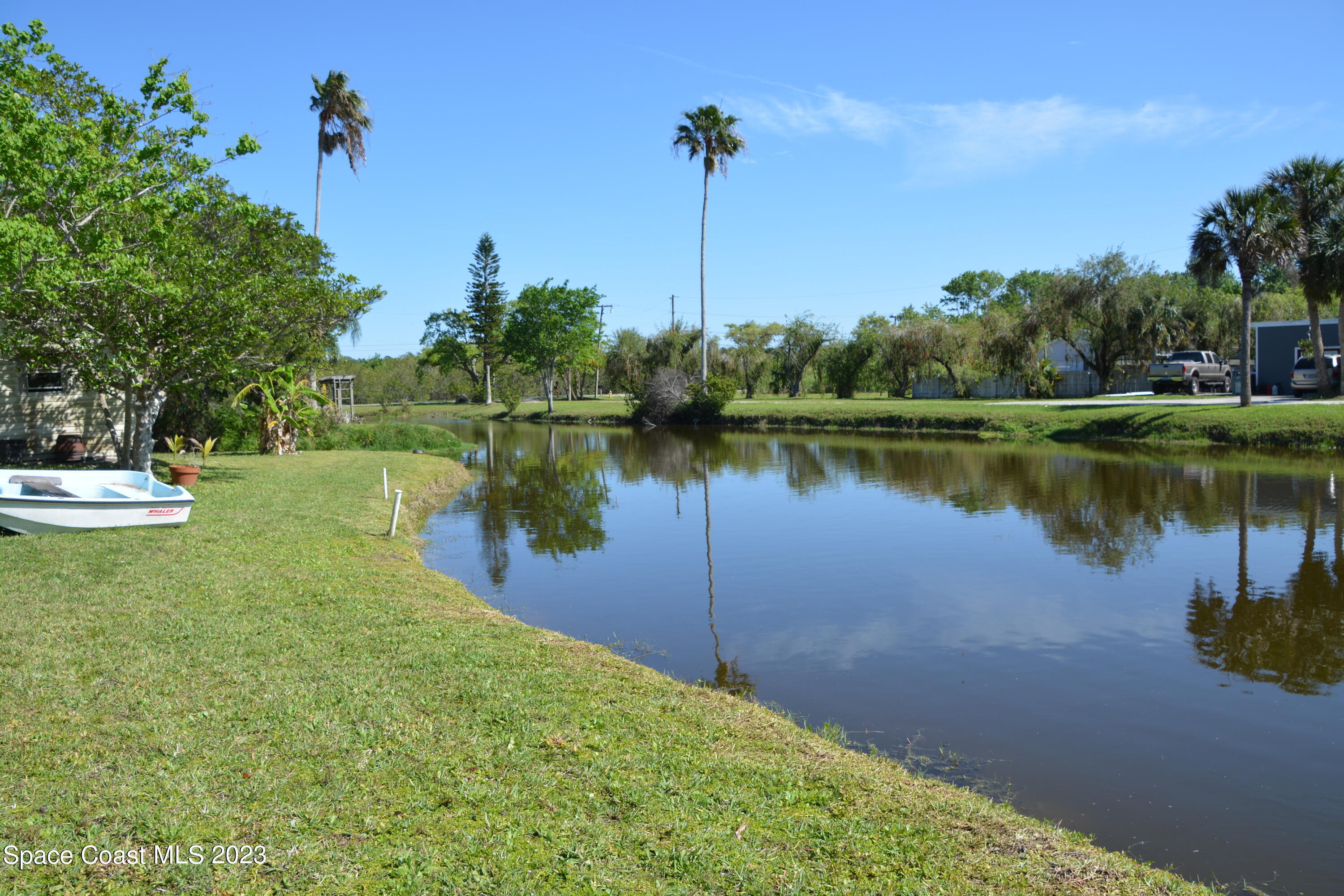 1045 Pine Island Road Merritt Island, FL 32953 - Photo 37 of 42 a view of a lake with a house in the background