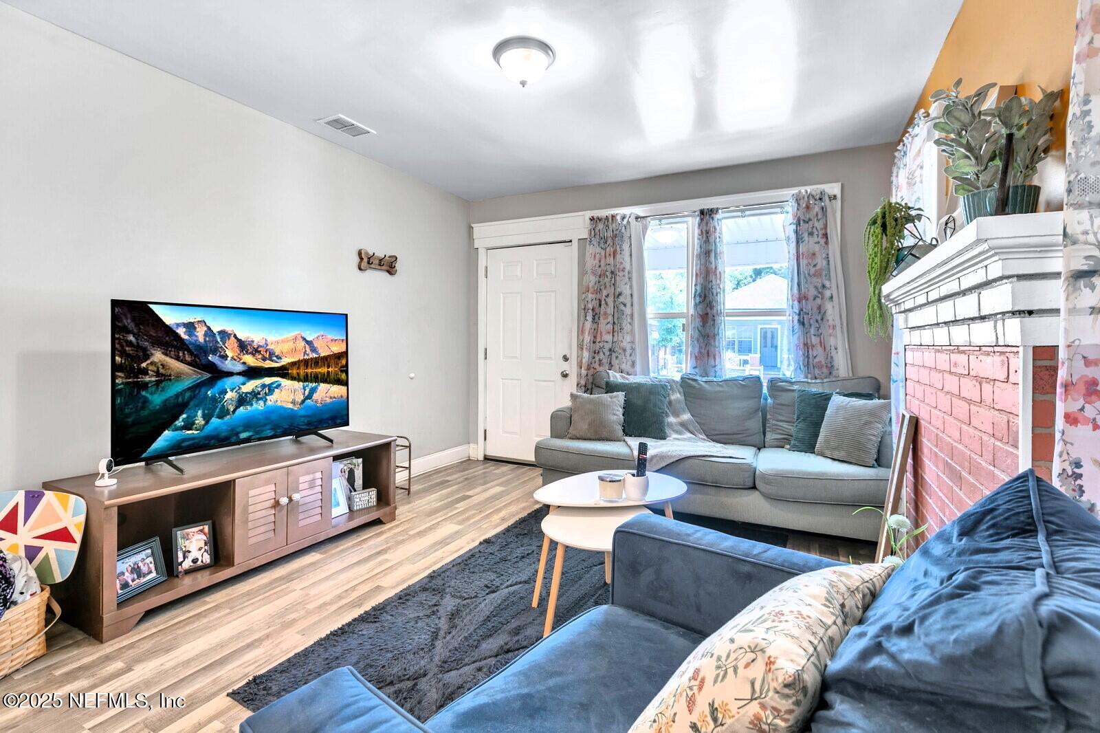 1336 Rushing Street Jacksonville, FL 32209 - Photo 13 of 19 a living room with furniture a flat screen tv and a fireplace