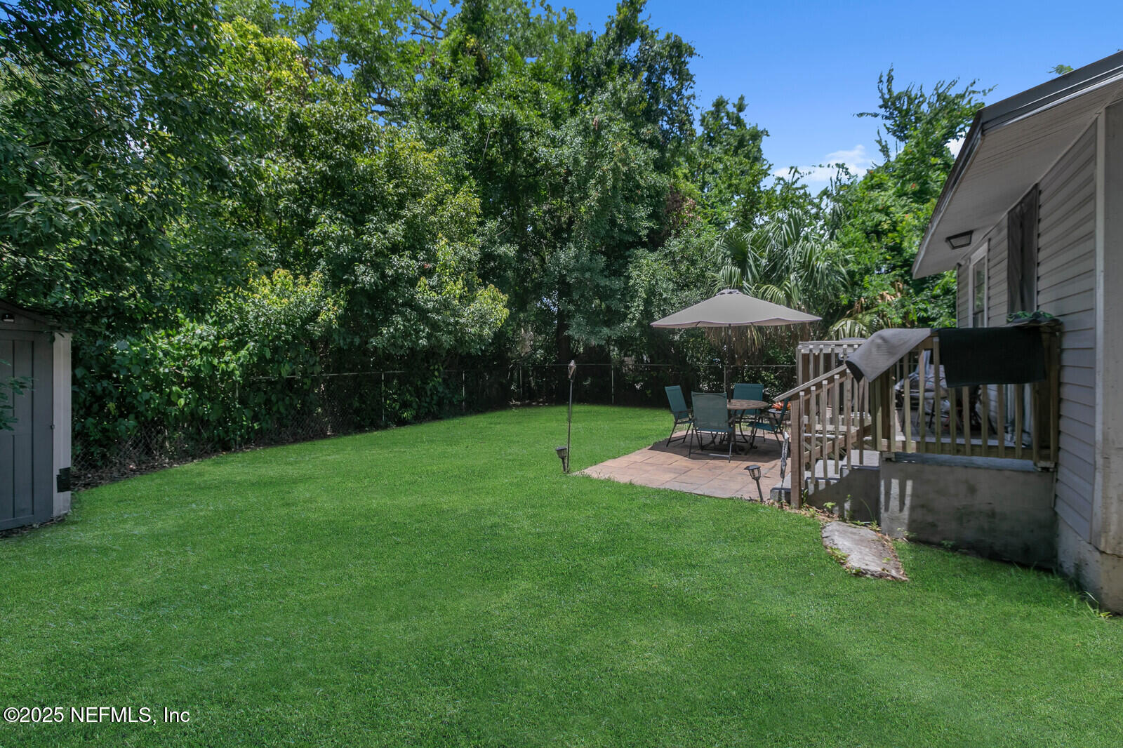 1336 Rushing Street Jacksonville, FL 32209 - Photo 17 of 19 a view of a chair and table in the garden in the backyard