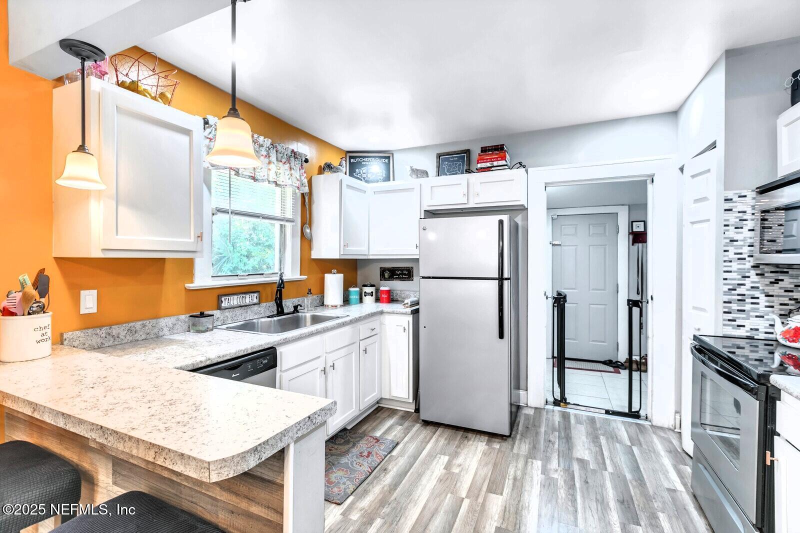 1336 Rushing Street Jacksonville, FL 32209 - Photo 2 of 19 a kitchen with refrigerator cabinets and wooden floor