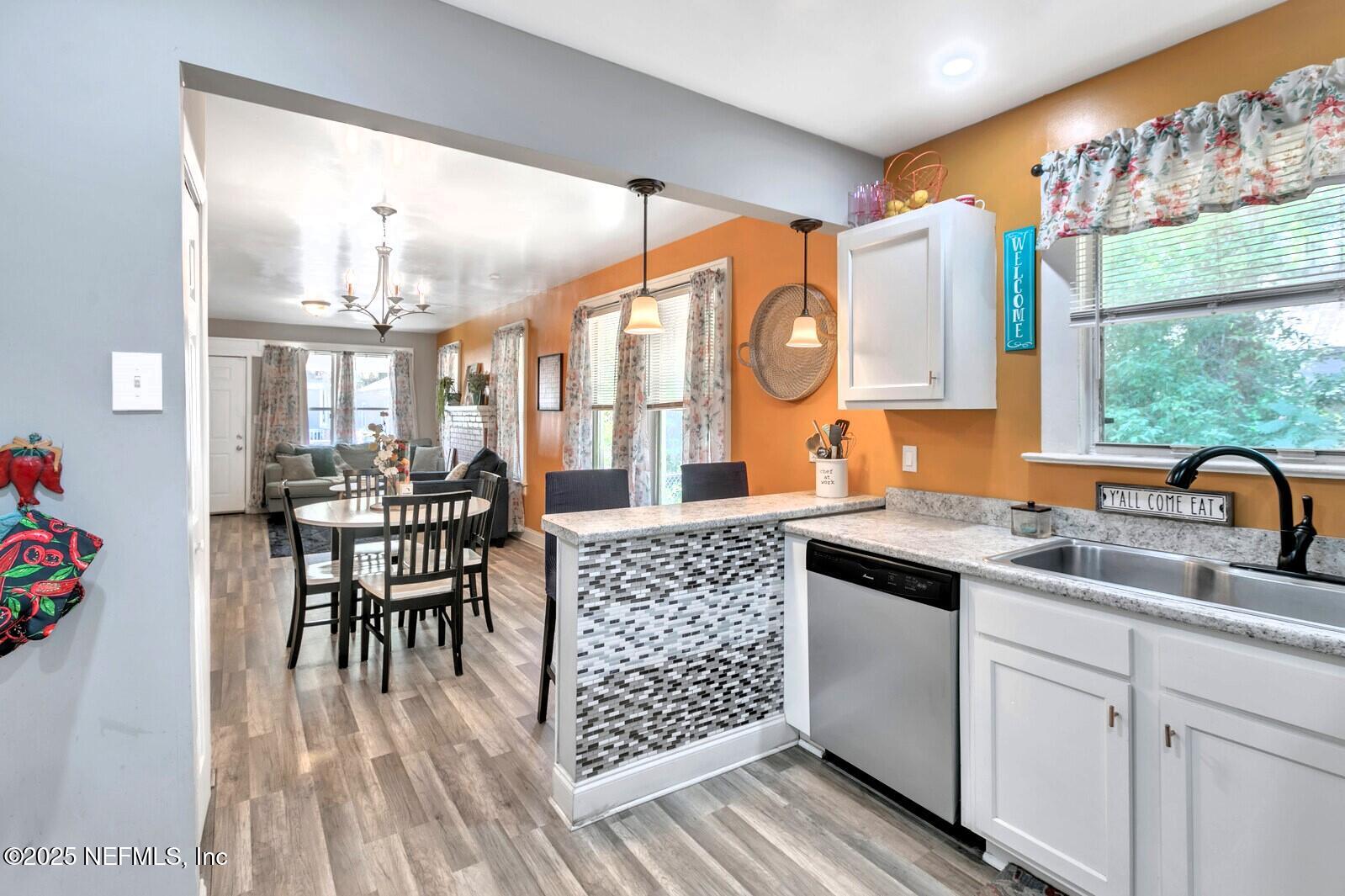 1336 Rushing Street Jacksonville, FL 32209 - Photo 4 of 19 a kitchen with stainless steel appliances granite countertop a stove a sink and a dining table view