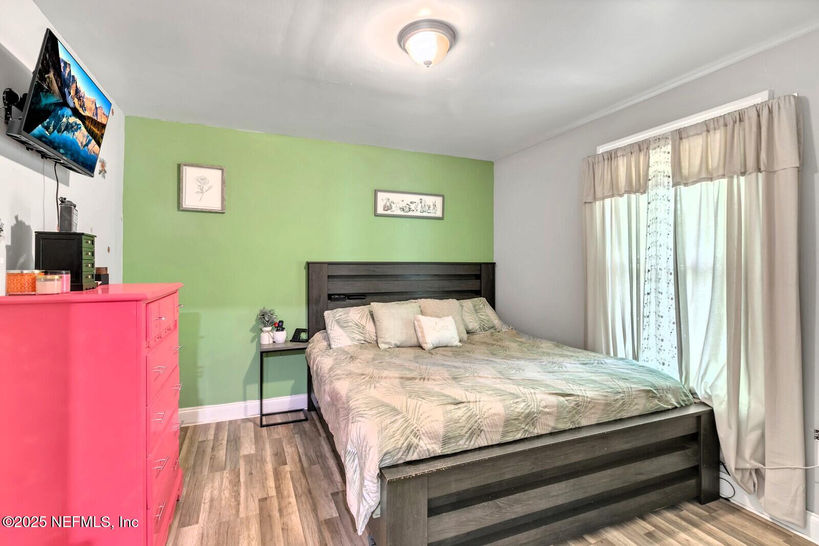 1336 Rushing Street Jacksonville, FL 32209 - Photo 9 of 19 a bedroom with a bed and a flat screen tv