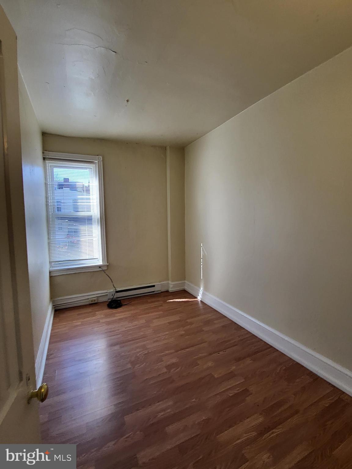 830 Church Street Reading, PA 19601 - Photo 7 of 12 an empty room with wooden floor and windows