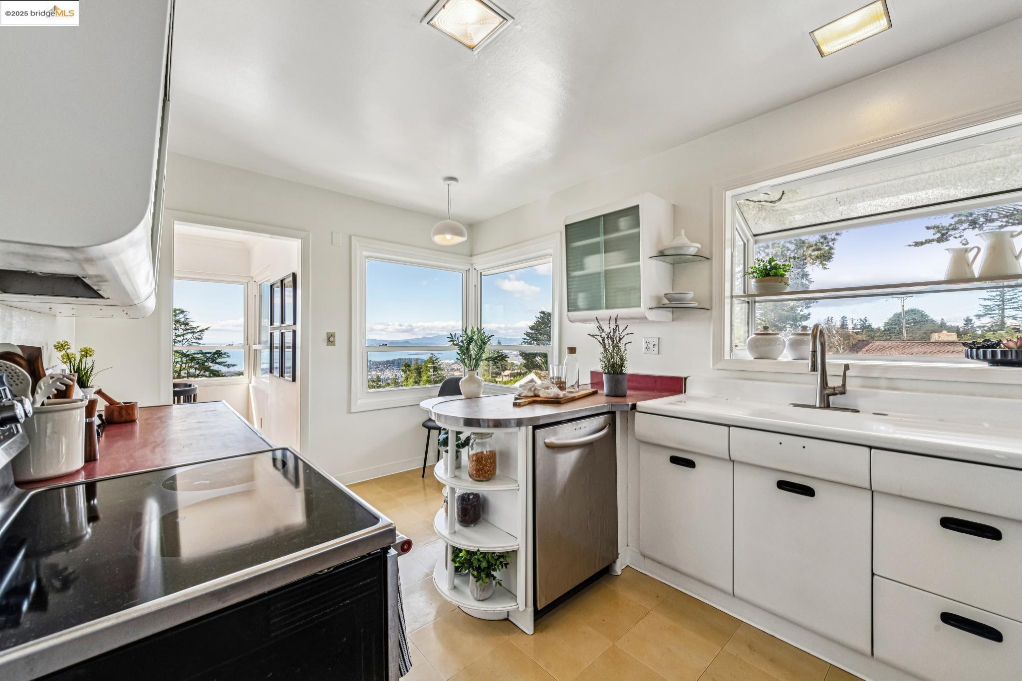 946 Creston Road Berkeley, CA 94708 - Photo 11 of 44 a kitchen with a sink stove and cabinets