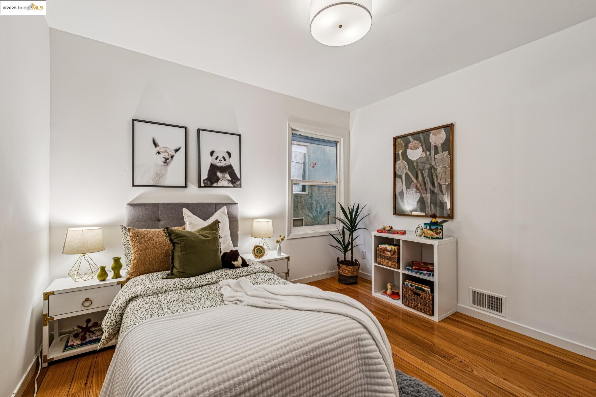 946 Creston Road Berkeley, CA 94708 - Photo 13 of 44 a bedroom with bed and wooden floor