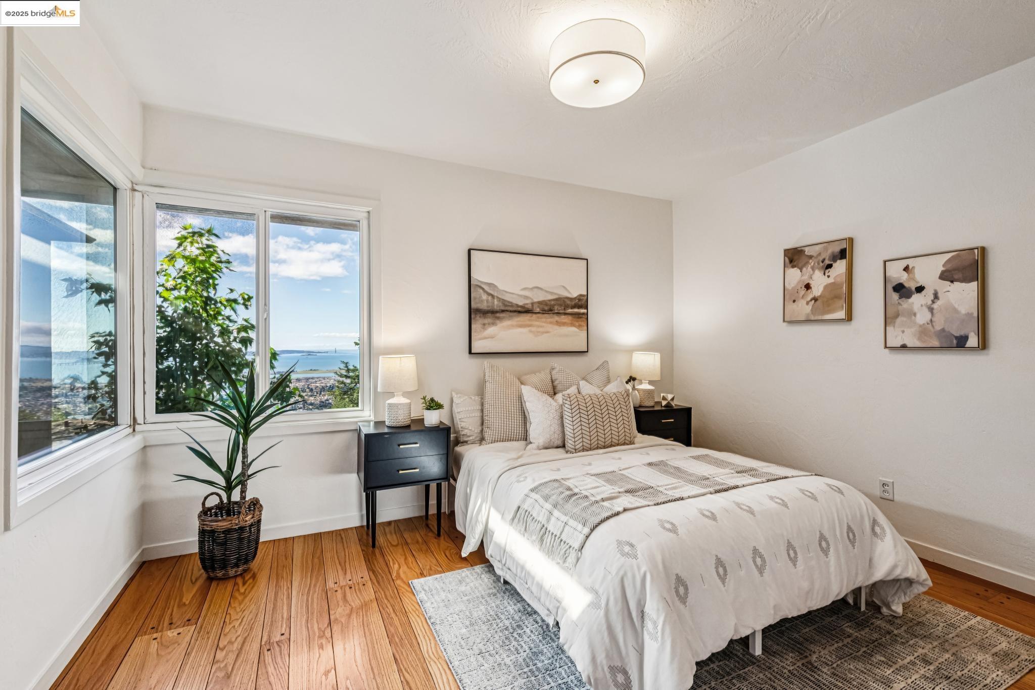 946 Creston Road Berkeley, CA 94708 - Photo 14 of 44 a bedroom with a large bed and a large window