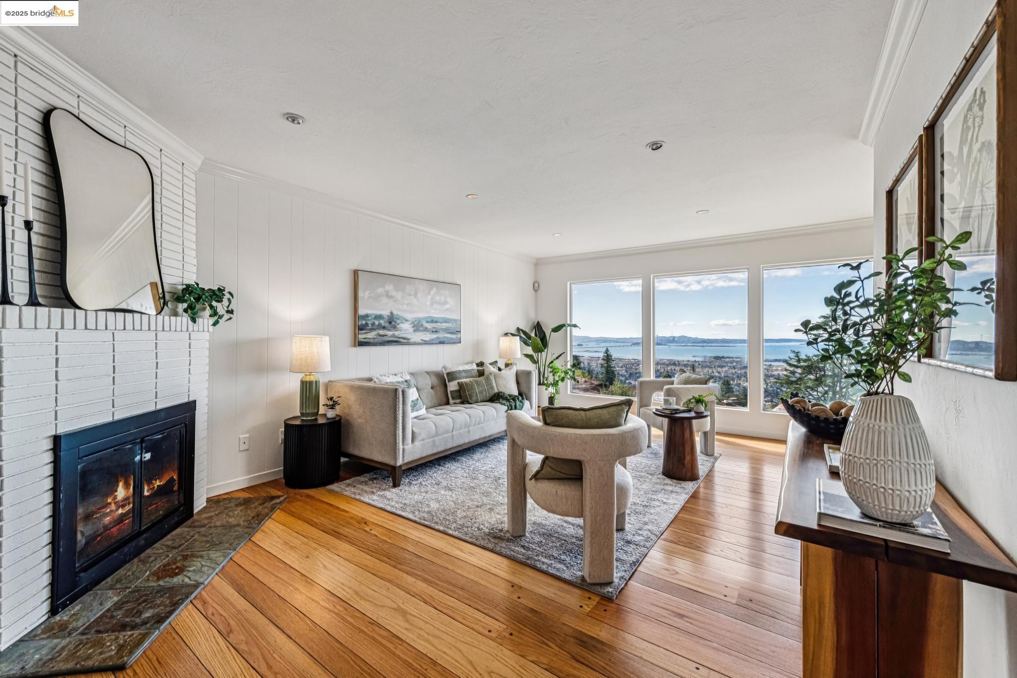 946 Creston Road Berkeley, CA 94708 - Photo 4 of 44 a living room with furniture a large window and a fireplace