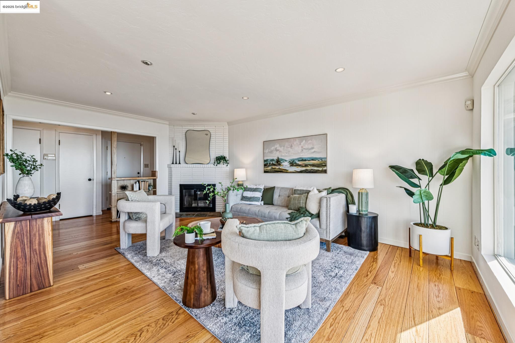 946 Creston Road Berkeley, CA 94708 - Photo 6 of 44 a living room with furniture a fireplace and a potted plant