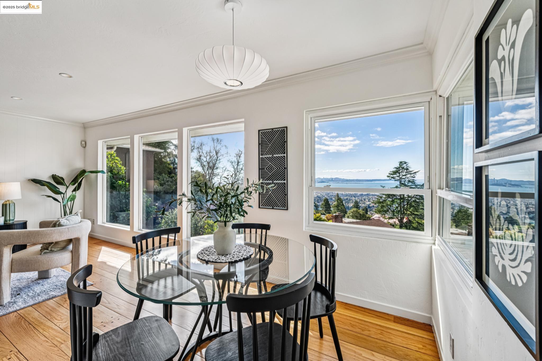 946 Creston Road Berkeley, CA 94708 - Photo 8 of 44 a dining room with furniture a chandelier and wooden floor