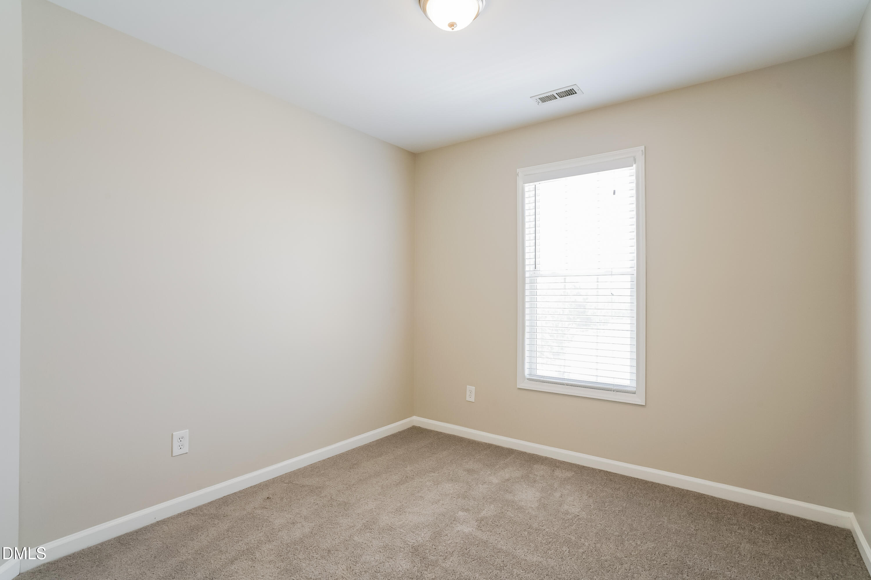 5436 Advantis Drive Raleigh, NC 27610 - Photo 12 of 15 an empty room with a window
