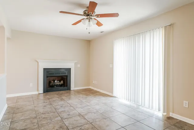 an empty room with windows and a fireplace