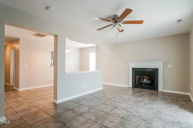 a view of an empty room and fire place