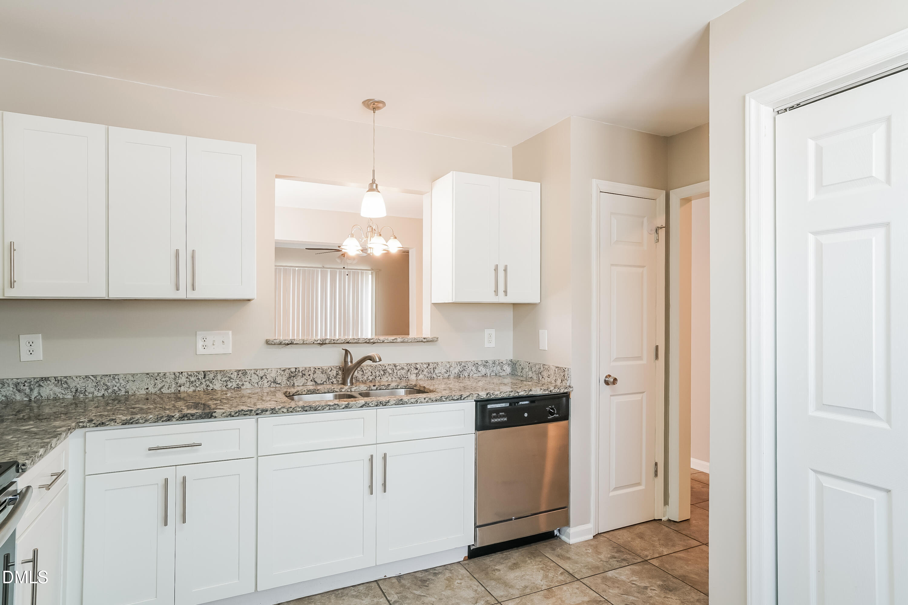 5436 Advantis Drive Raleigh, NC 27610 - Photo 6 of 15 a kitchen with granite countertop white cabinets white stainless steel appliances with a sink and dishwasher