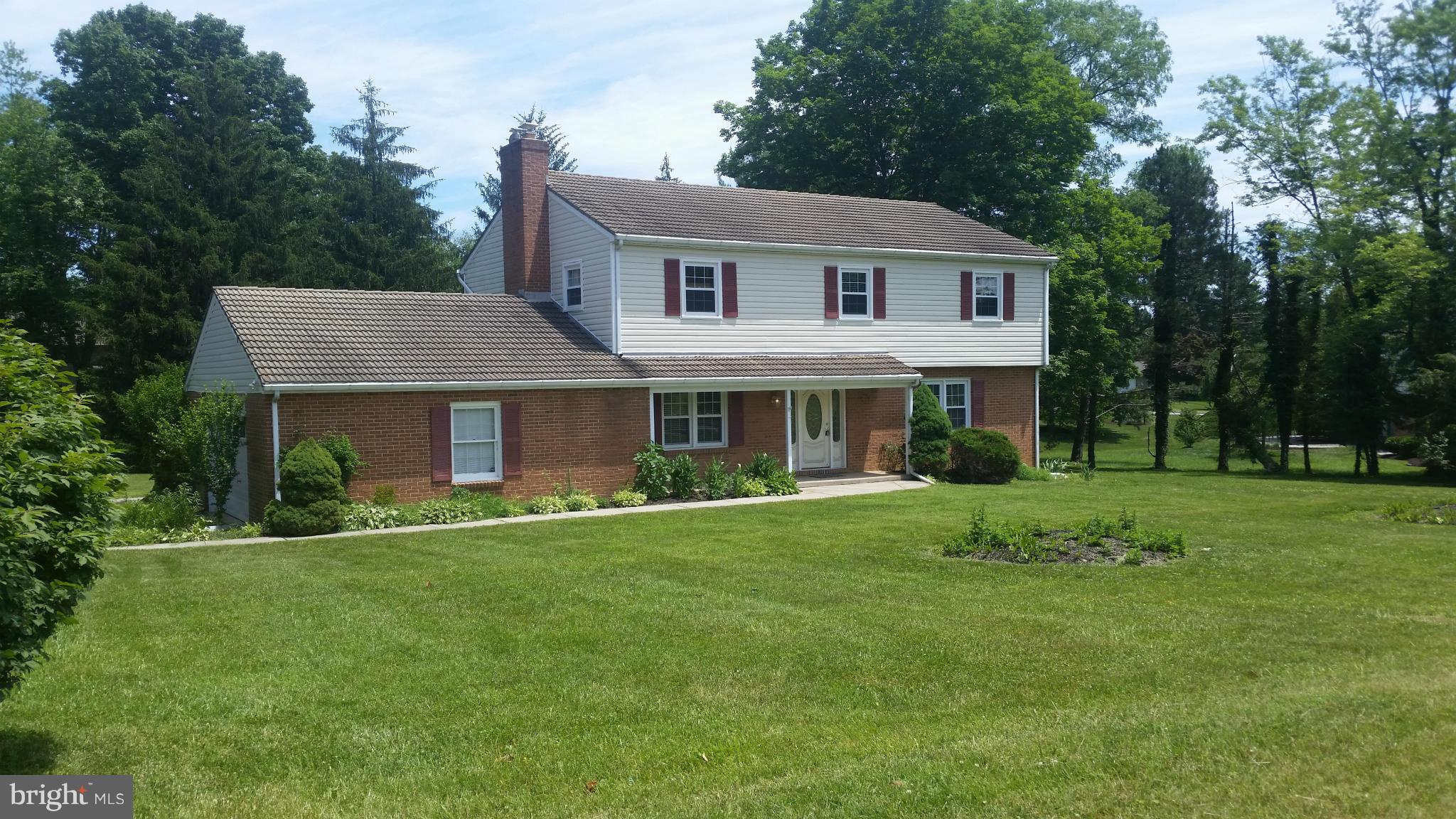 2119 Pot Spring Road Lutherville-Timonium, MD 21093 - Photo 1 of 30 a front view of a house with a garden