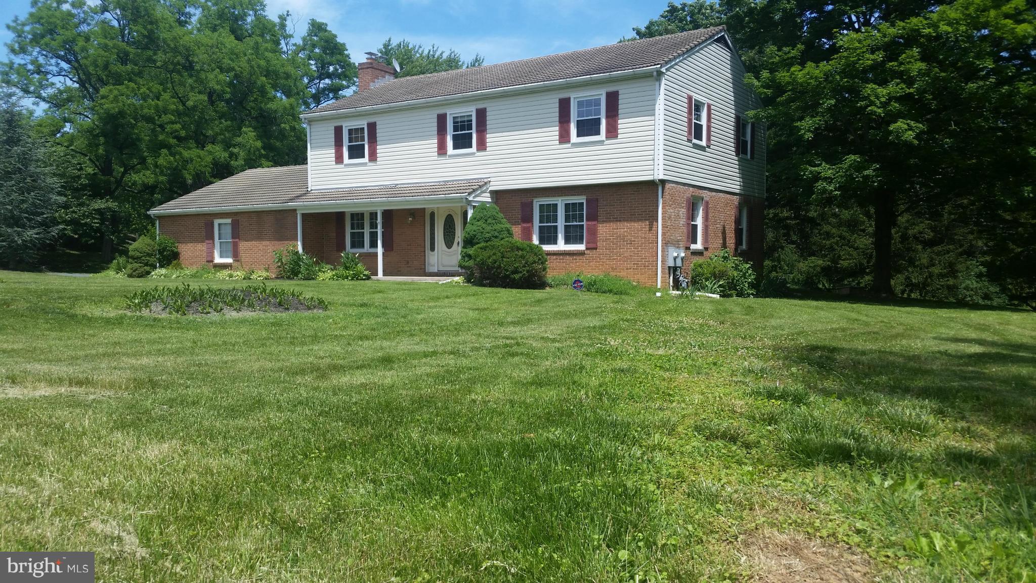 2119 Pot Spring Road Lutherville-Timonium, MD 21093 - Photo 2 of 30 a front view of a house with a garden