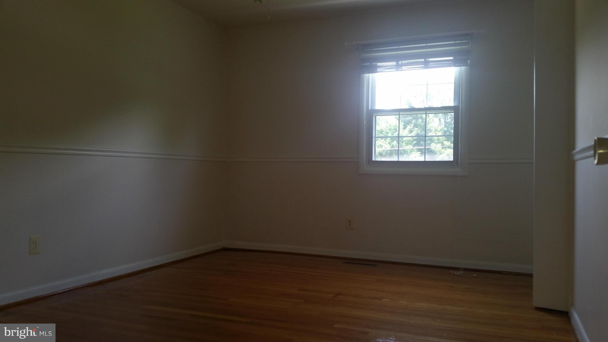 2119 Pot Spring Road Lutherville-Timonium, MD 21093 - Photo 16 of 30 a view of an empty room with wooden floor and a window