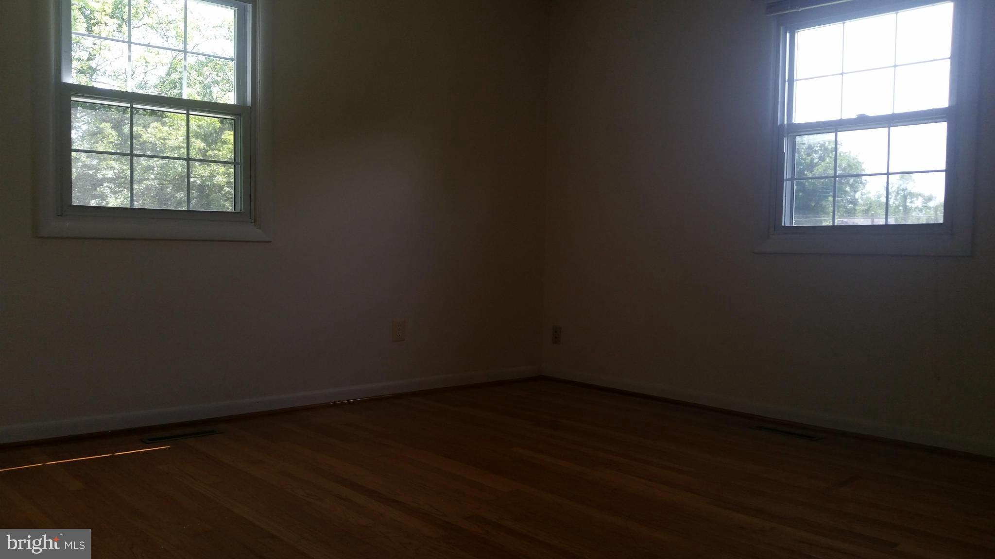 2119 Pot Spring Road Lutherville-Timonium, MD 21093 - Photo 17 of 30 an empty room with wooden floor and windows