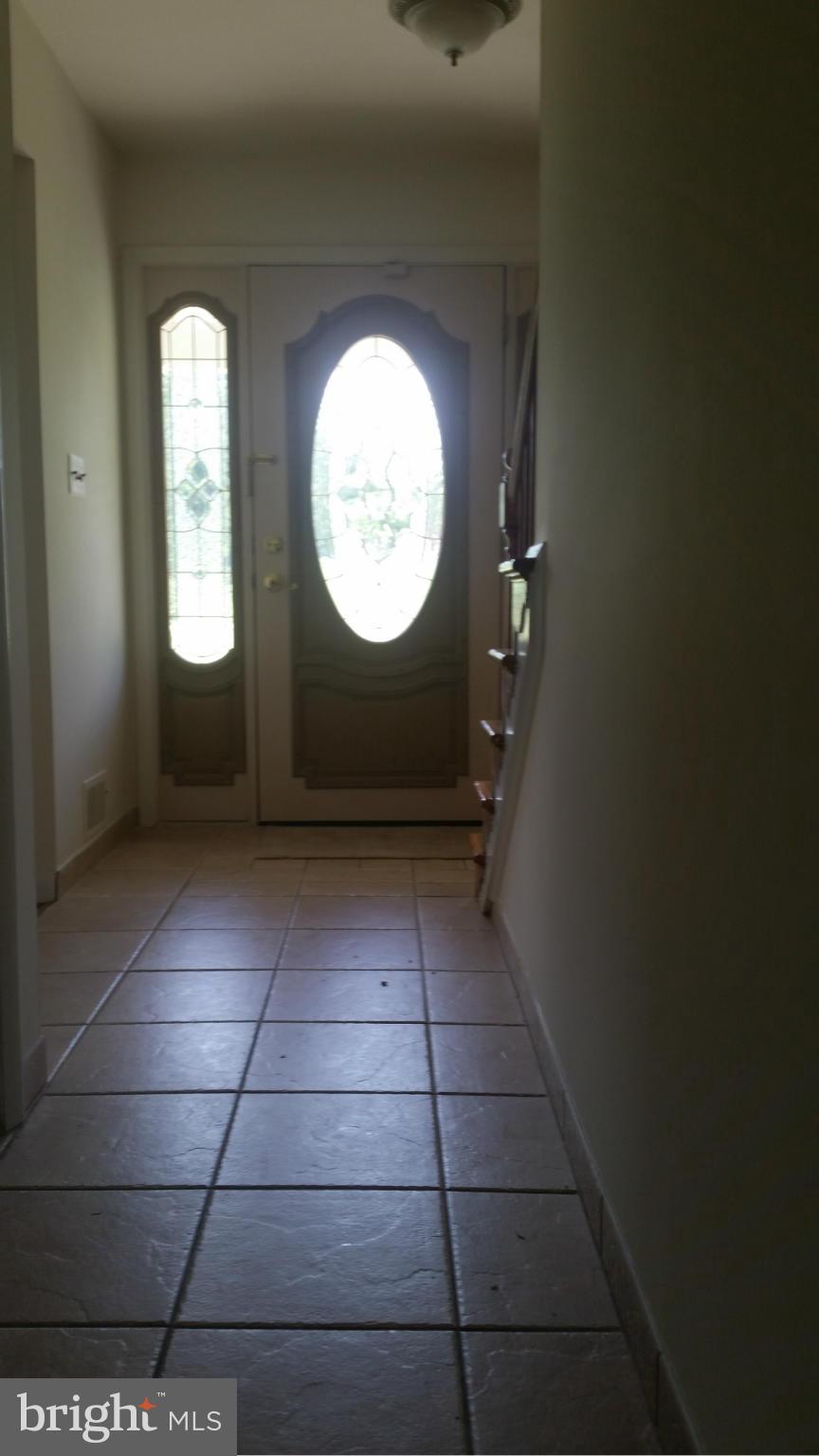 2119 Pot Spring Road Lutherville-Timonium, MD 21093 - Photo 3 of 30 an empty room with wooden floor and a window