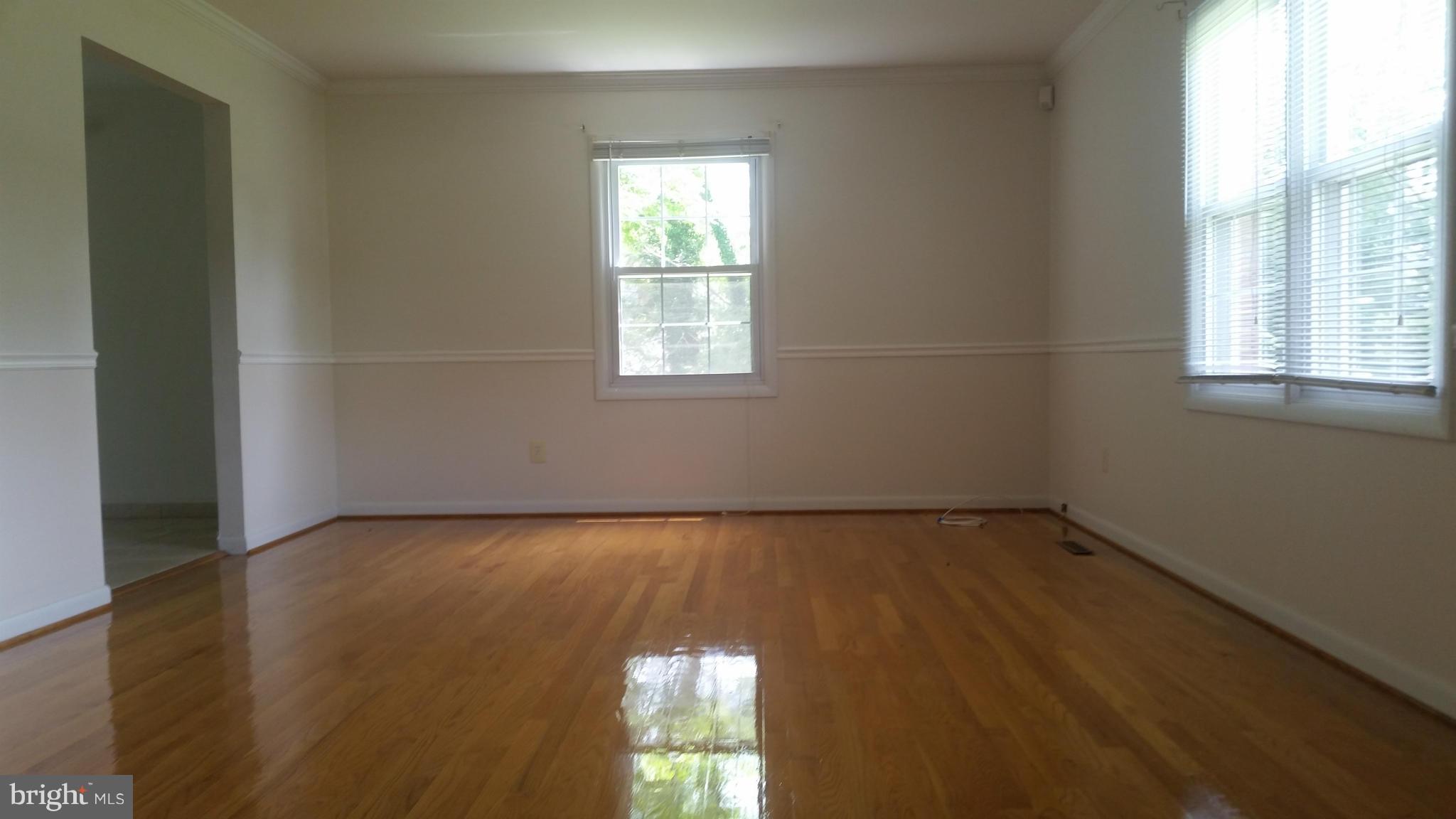 2119 Pot Spring Road Lutherville-Timonium, MD 21093 - Photo 7 of 30 an empty room with wooden floor and windows