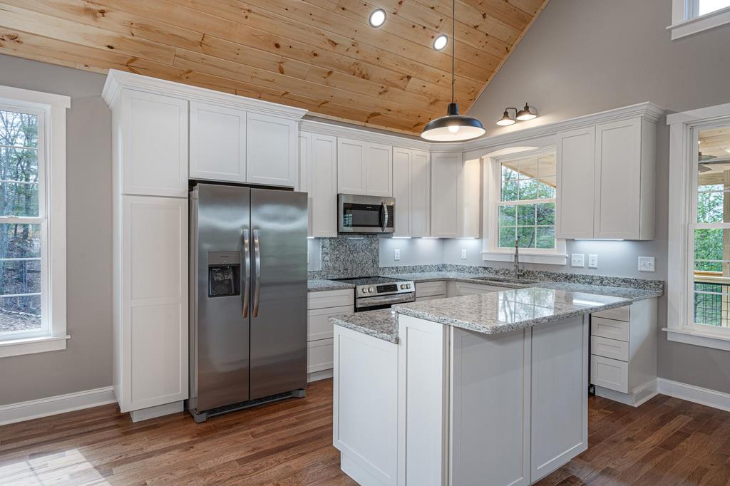 259 River Mountain Road Murphy, NC 28906 - Photo 15 of 42 a kitchen with stainless steel appliances granite countertop a stove a refrigerator and a microwave