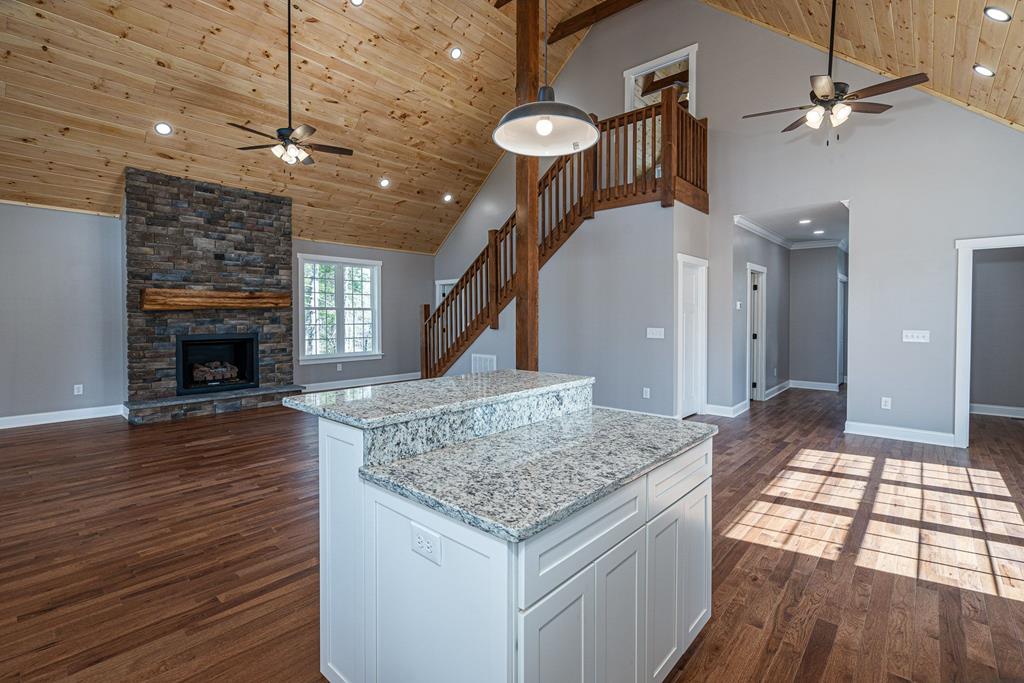 259 River Mountain Road Murphy, NC 28906 - Photo 18 of 42 a kitchen with kitchen island granite countertop a stove and a wooden floor