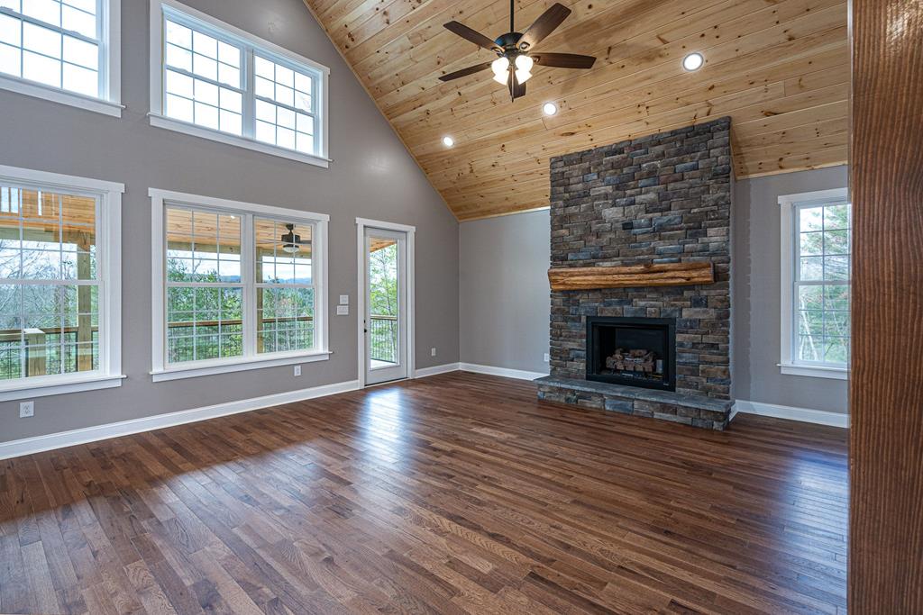 259 River Mountain Road Murphy, NC 28906 - Photo 19 of 42 a view of an empty room with wooden floor fireplace and a window