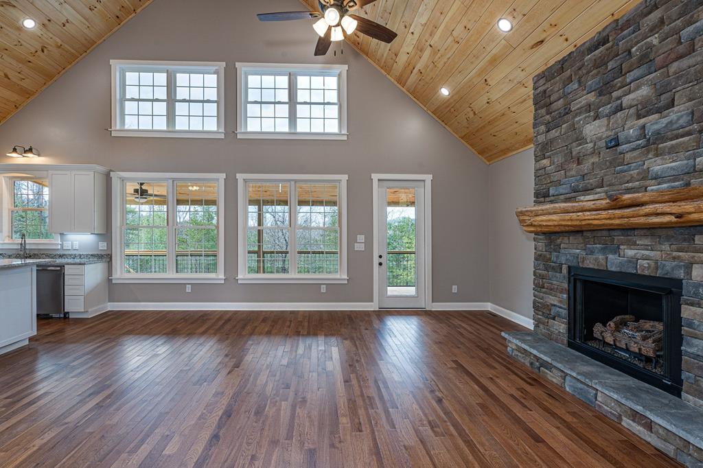259 River Mountain Road Murphy, NC 28906 - Photo 20 of 42 a living room with wooden floors and a fireplace