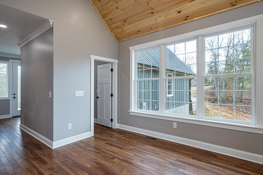 259 River Mountain Road Murphy, NC 28906 - Photo 21 of 42 an empty room with wooden floor and windows