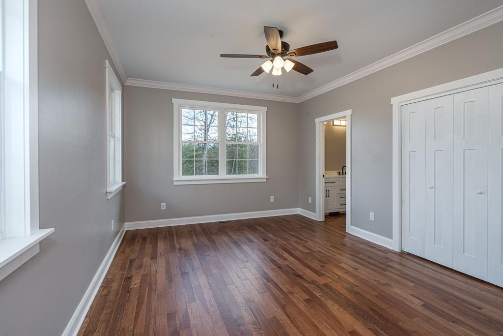259 River Mountain Road Murphy, NC 28906 - Photo 23 of 42 a view of an empty room with wooden floor and a window