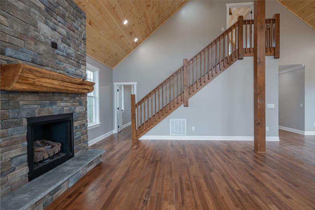 259 River Mountain Road Murphy, NC 28906 - Photo 26 of 42 a view of an empty room with wooden floor a fireplace