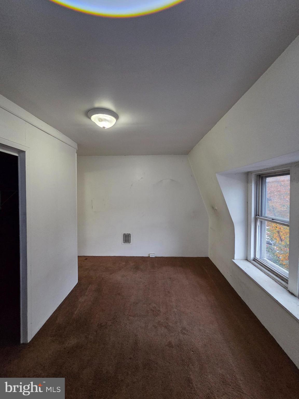 1024 North 11th Street Reading, PA 19604 - Photo 18 of 23 an empty room with windows and closet