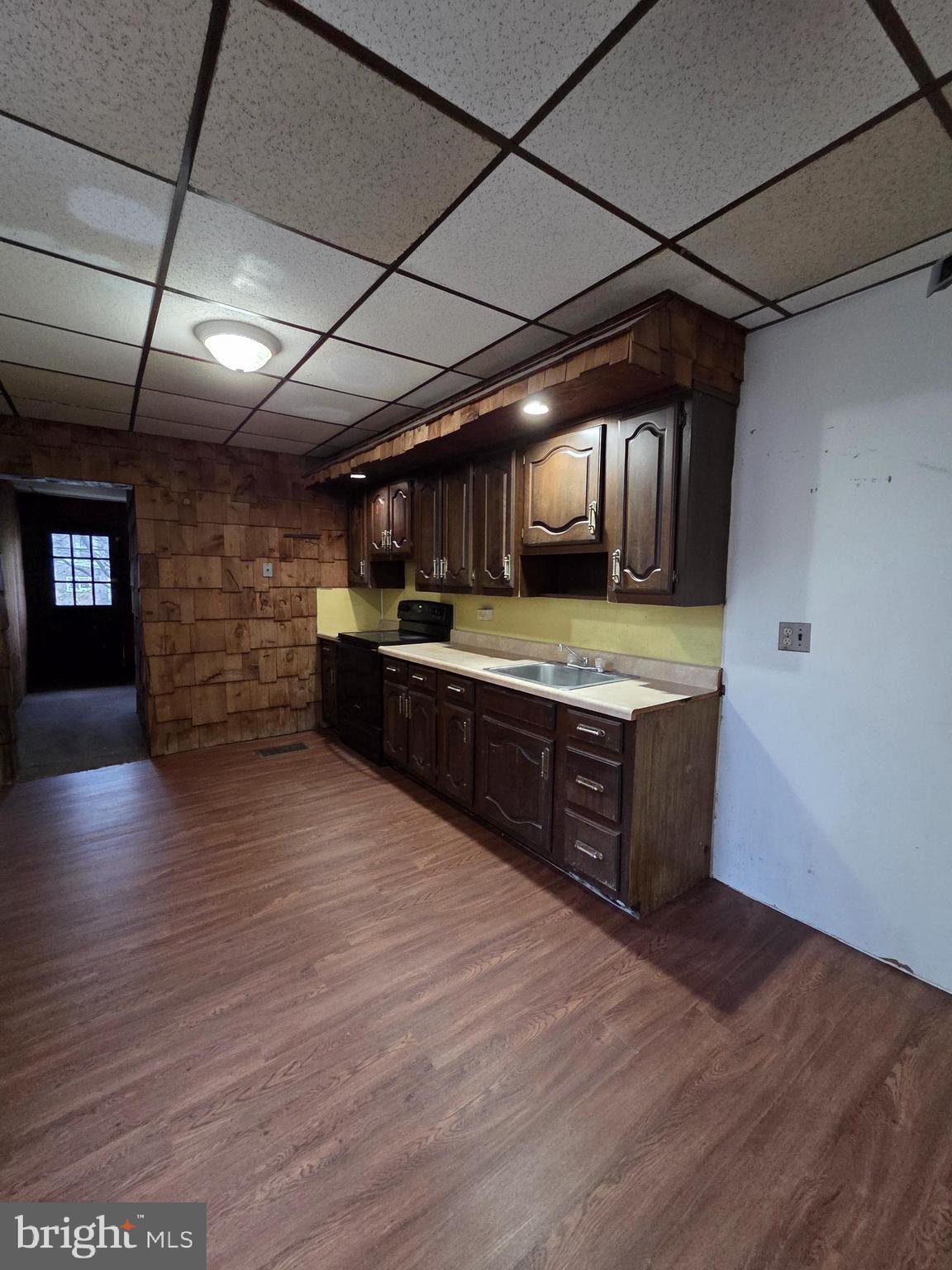 1024 North 11th Street Reading, PA 19604 - Photo 4 of 23 a large kitchen with stainless steel appliances granite countertop a sink and wooden cabinets