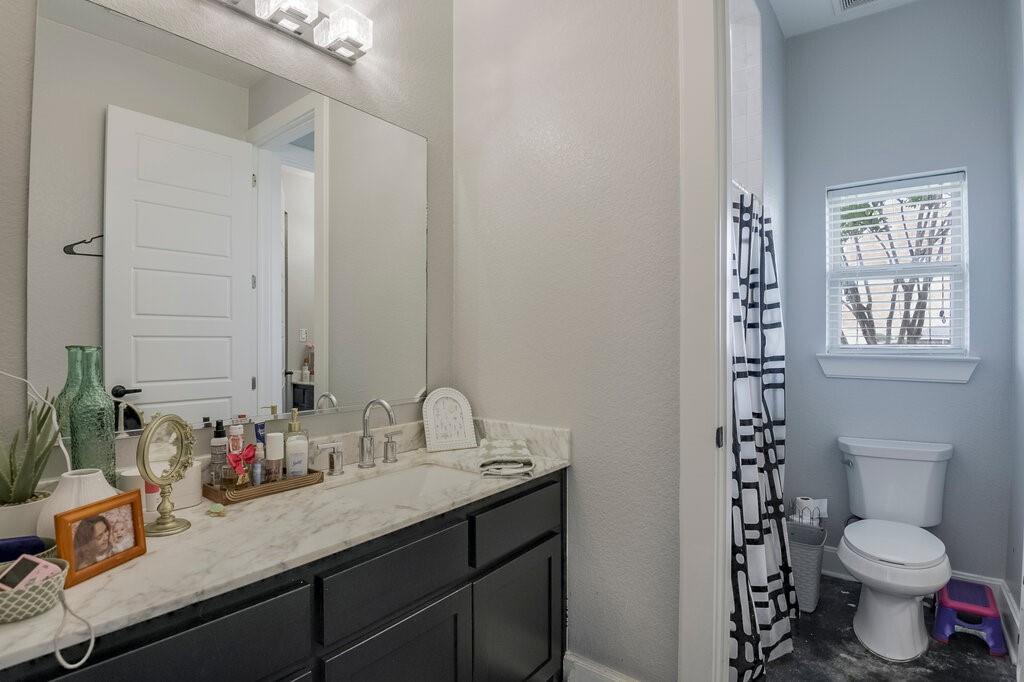 239 North Armstrong Road Venus, TX 76084 - Photo 22 of 39 Bathroom featuring a dark wood vanity with a white stone countertop, undermount sink, and brushed nickel faucet