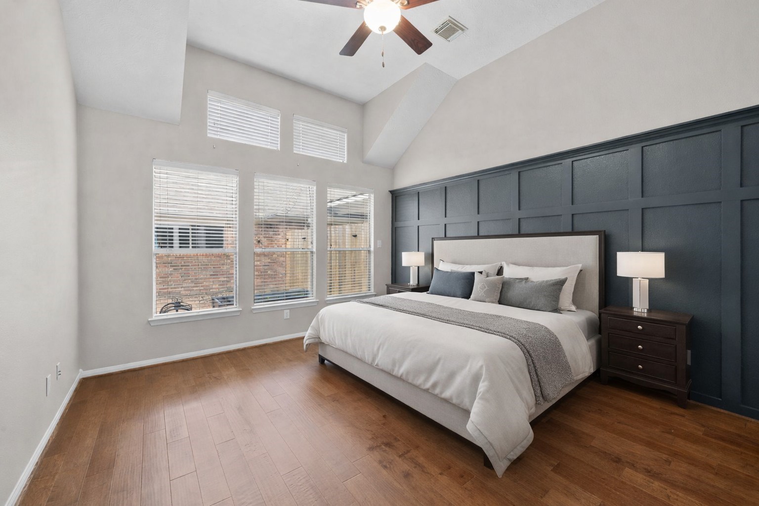 226 Whispering Ridge Terrace Houston, TX 77094 - Photo 12 of 31 a large bedroom with a bed and a large window with wooden floor