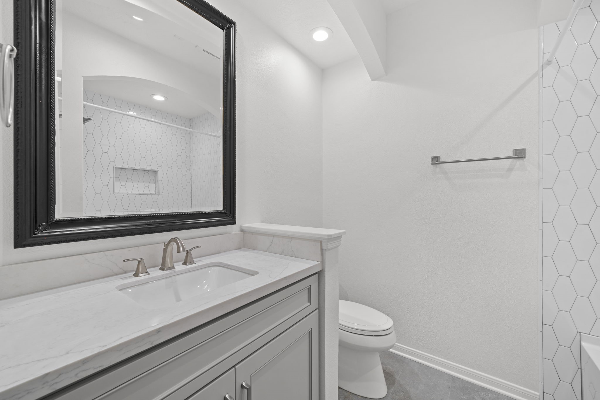 226 Whispering Ridge Terrace Houston, TX 77094 - Photo 19 of 31 a bathroom with a granite countertop sink a toilet and a mirror