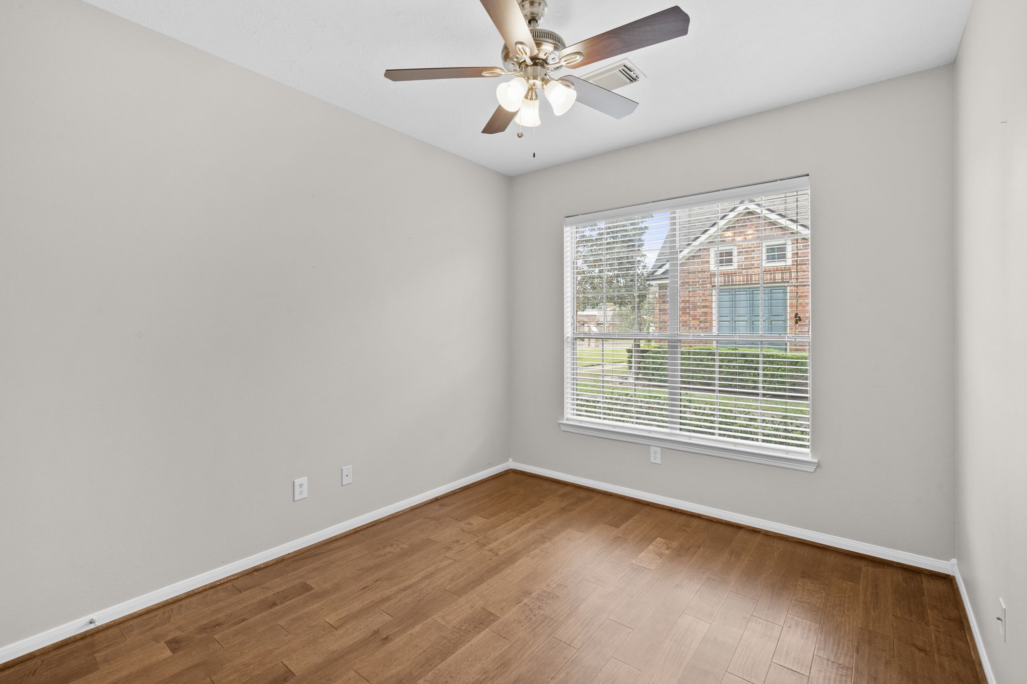 226 Whispering Ridge Terrace Houston, TX 77094 - Photo 28 of 31 a view of an empty room with a window and wooden floor