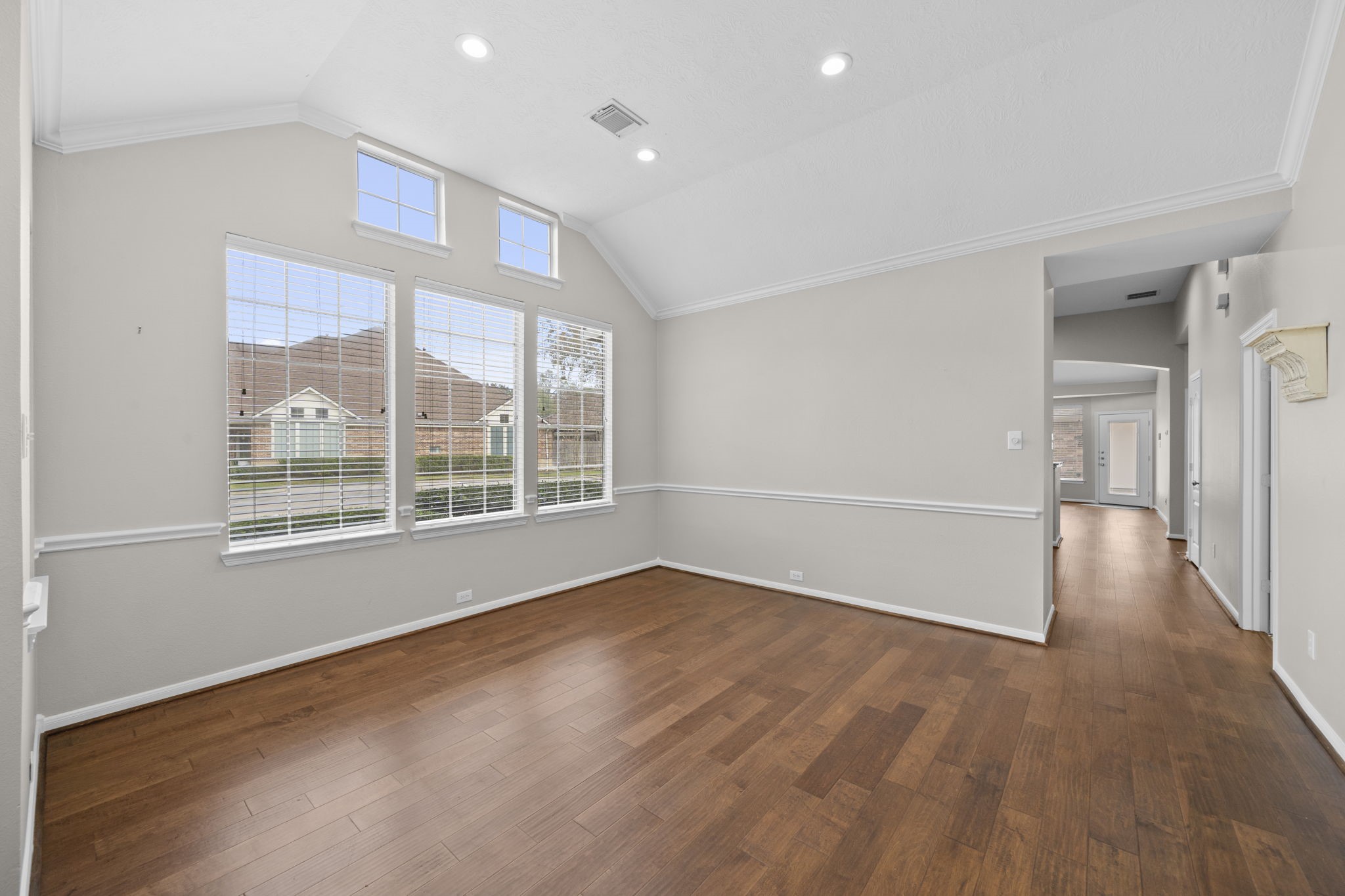 226 Whispering Ridge Terrace Houston, TX 77094 - Photo 3 of 31 a view of an empty room with wooden floor and a window