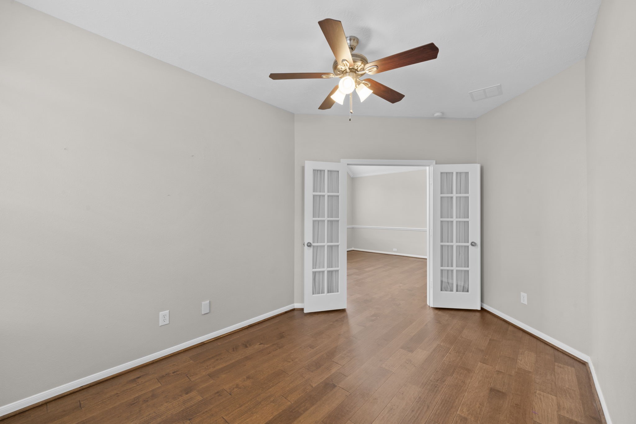 226 Whispering Ridge Terrace Houston, TX 77094 - Photo 5 of 31 an empty room with wooden floor and windows