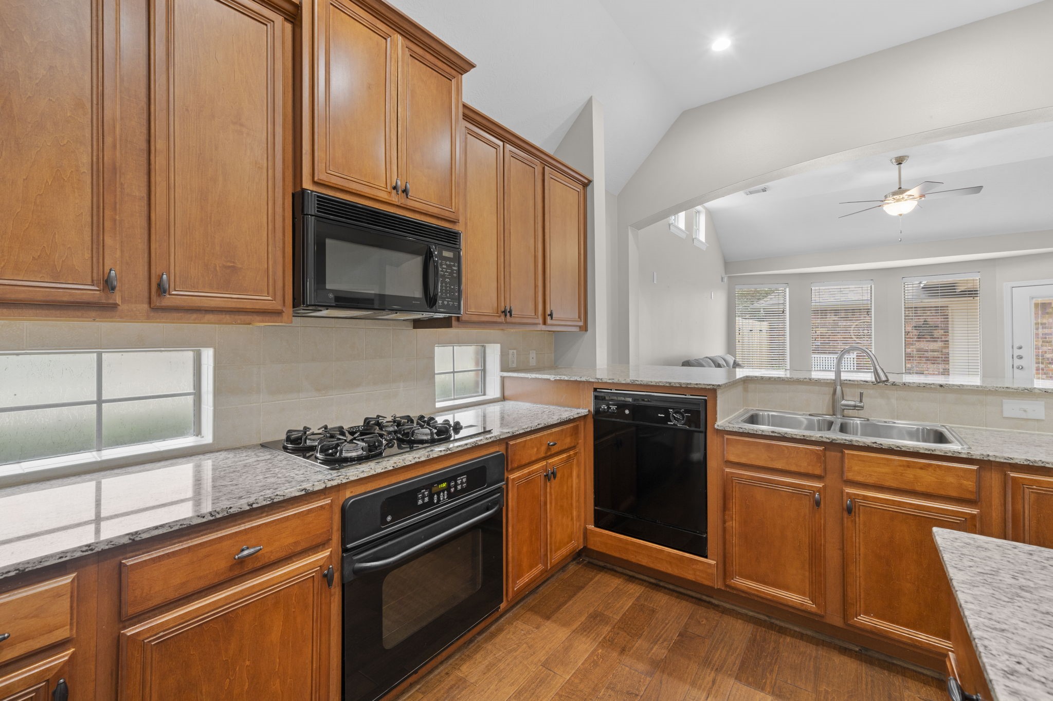 226 Whispering Ridge Terrace Houston, TX 77094 - Photo 7 of 31 a kitchen with stainless steel appliances granite countertop a stove a sink and a microwave