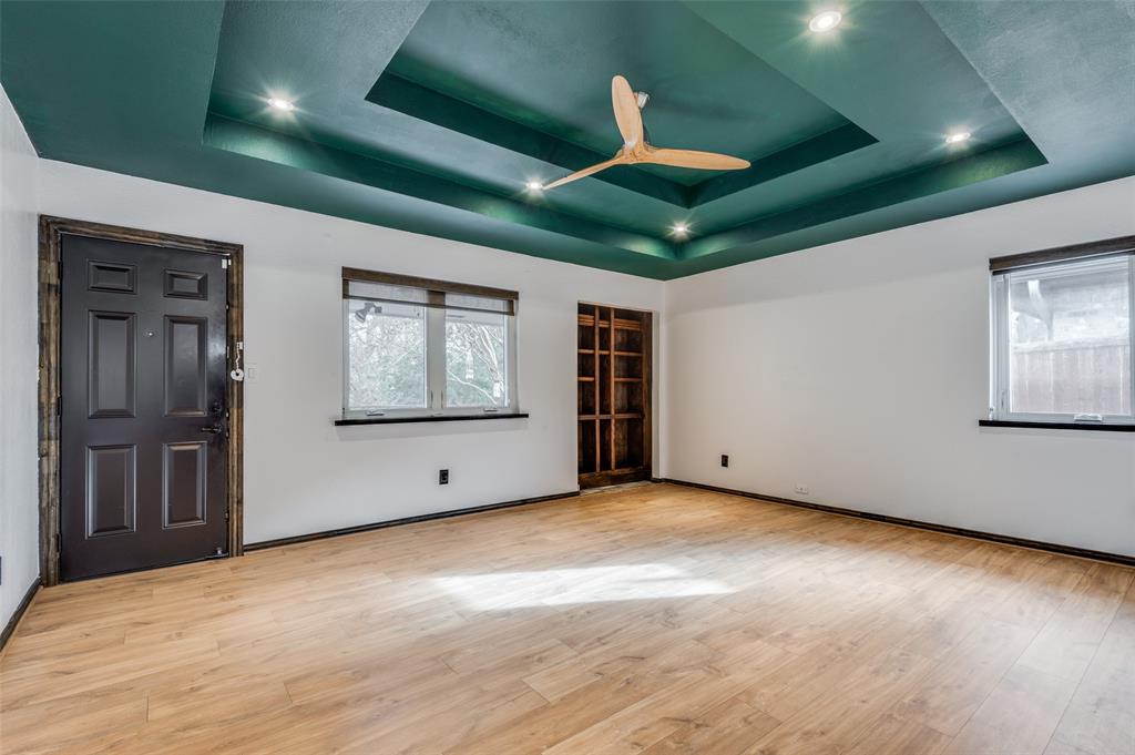2749 Buna Drive Dallas, TX 75211 - Photo 2 of 12 Ly room with a tray ceiling, light wood-style flooring, and ceiling fan