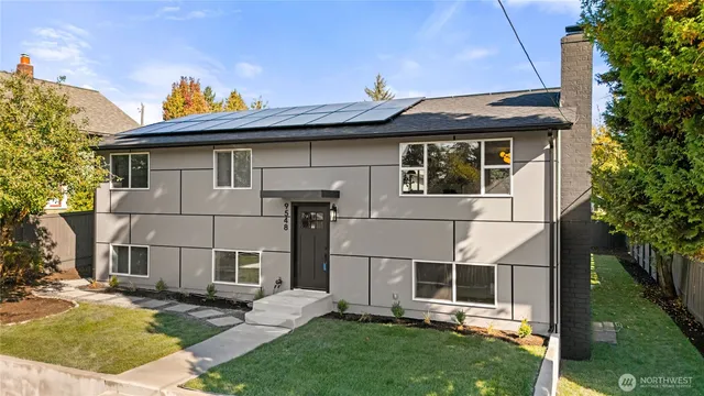 a view of a house with a yard and sitting area