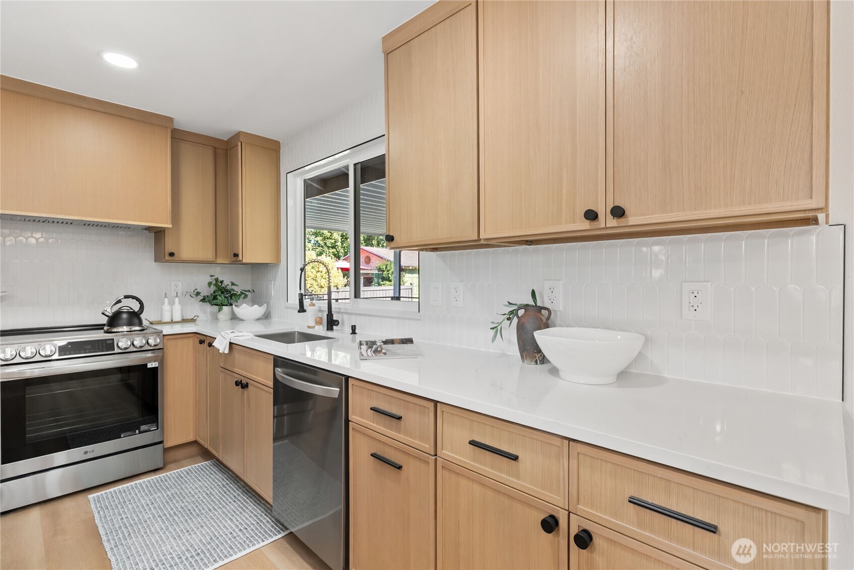 9548 3rd Avenue Northwest Seattle, WA 98117 - Photo 14 of 40 a kitchen with stainless steel appliances granite countertop a sink and a stove