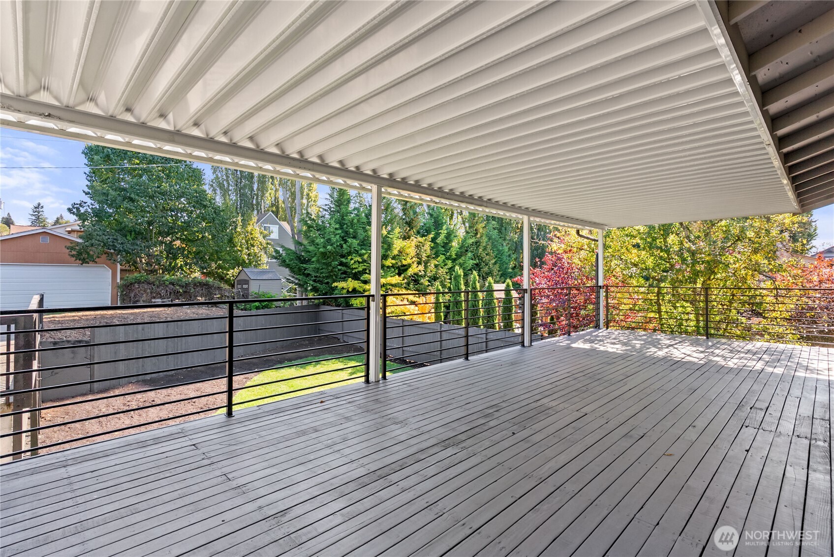 9548 3rd Avenue Northwest Seattle, WA 98117 - Photo 16 of 40 a view of a deck with wooden floor and a yard
