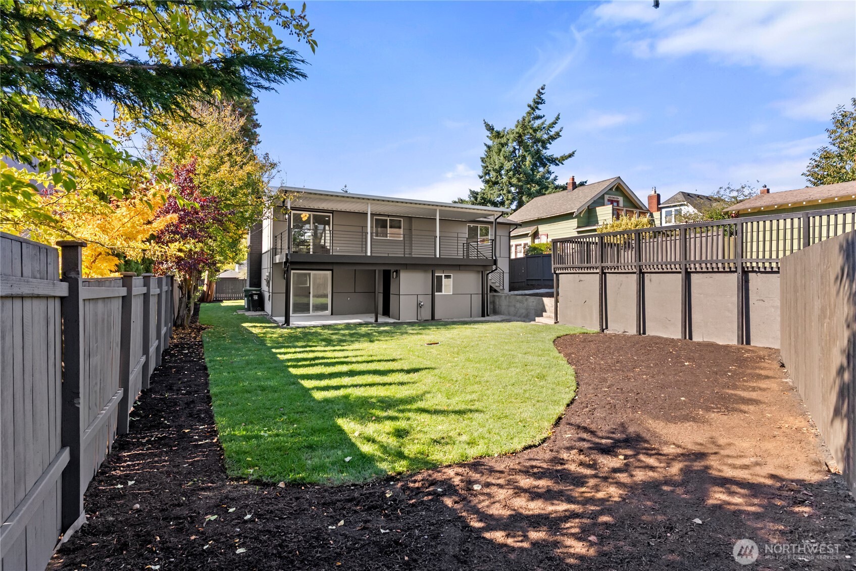 9548 3rd Avenue Northwest Seattle, WA 98117 - Photo 35 of 40 a view of a white house with a big yard and potted plants