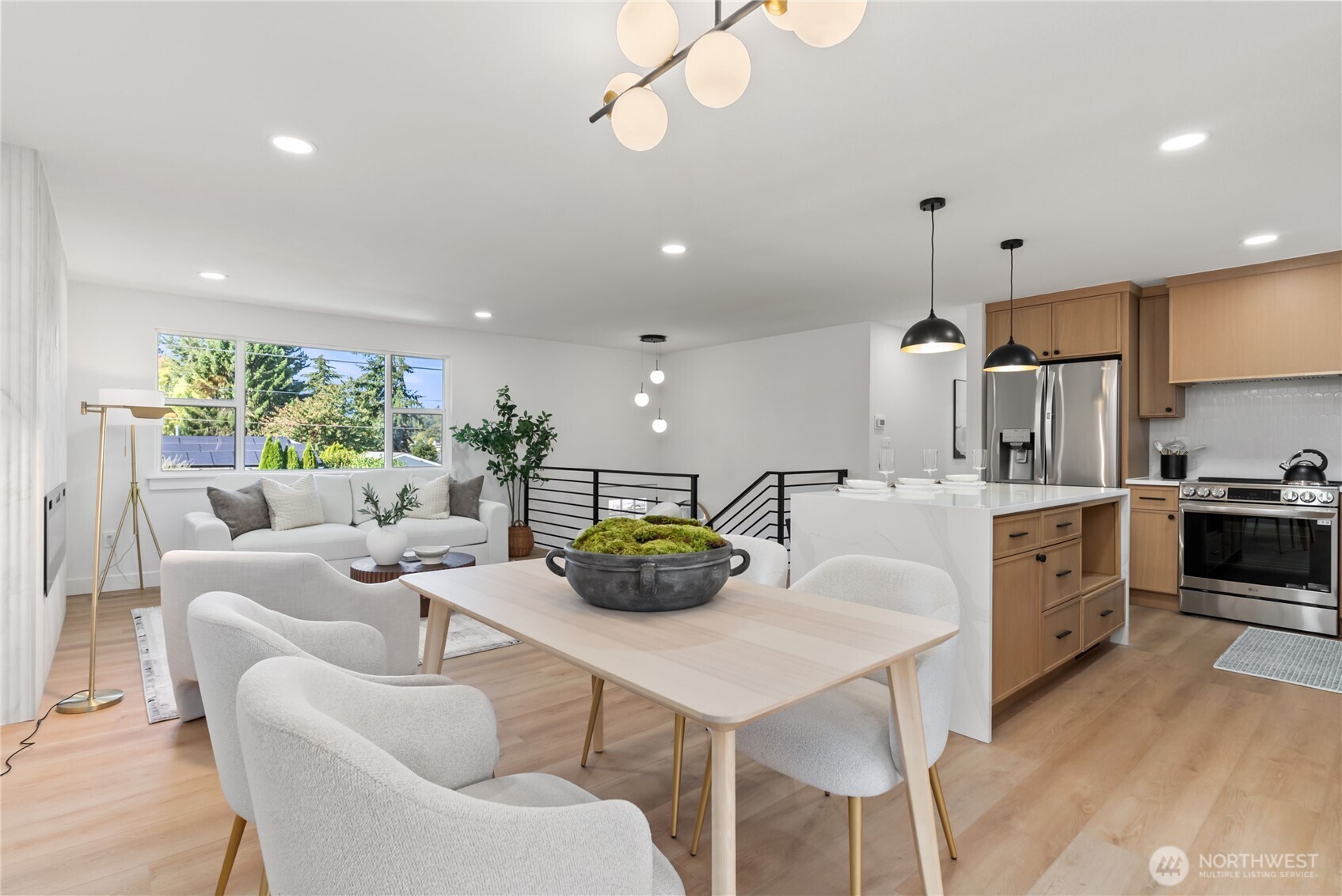 9548 3rd Avenue Northwest Seattle, WA 98117 - Photo 7 of 40 a kitchen with stainless steel appliances kitchen island granite countertop a sink a stove a dining table and chairs