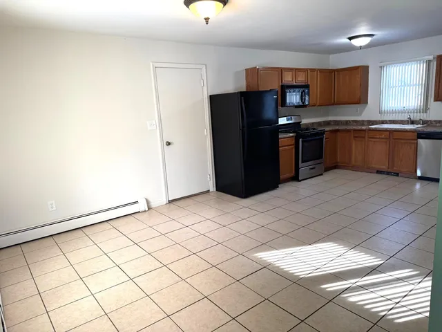 a kitchen with stainless steel appliances a refrigerator and a stove top oven
