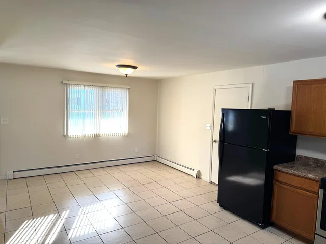 a kitchen with a refrigerator and window