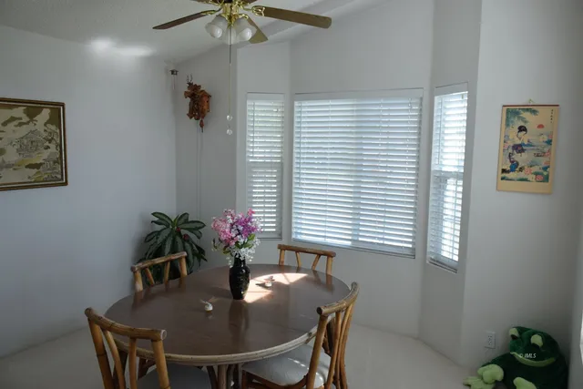 a dining room with furniture and window