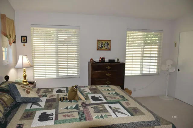 a bedroom with furniture and a window