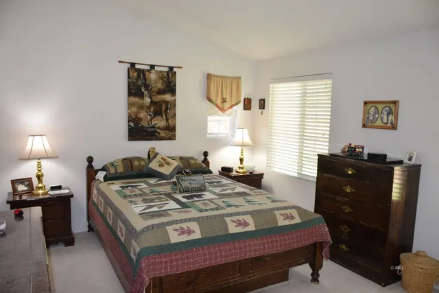 a bed room with a bed and a window